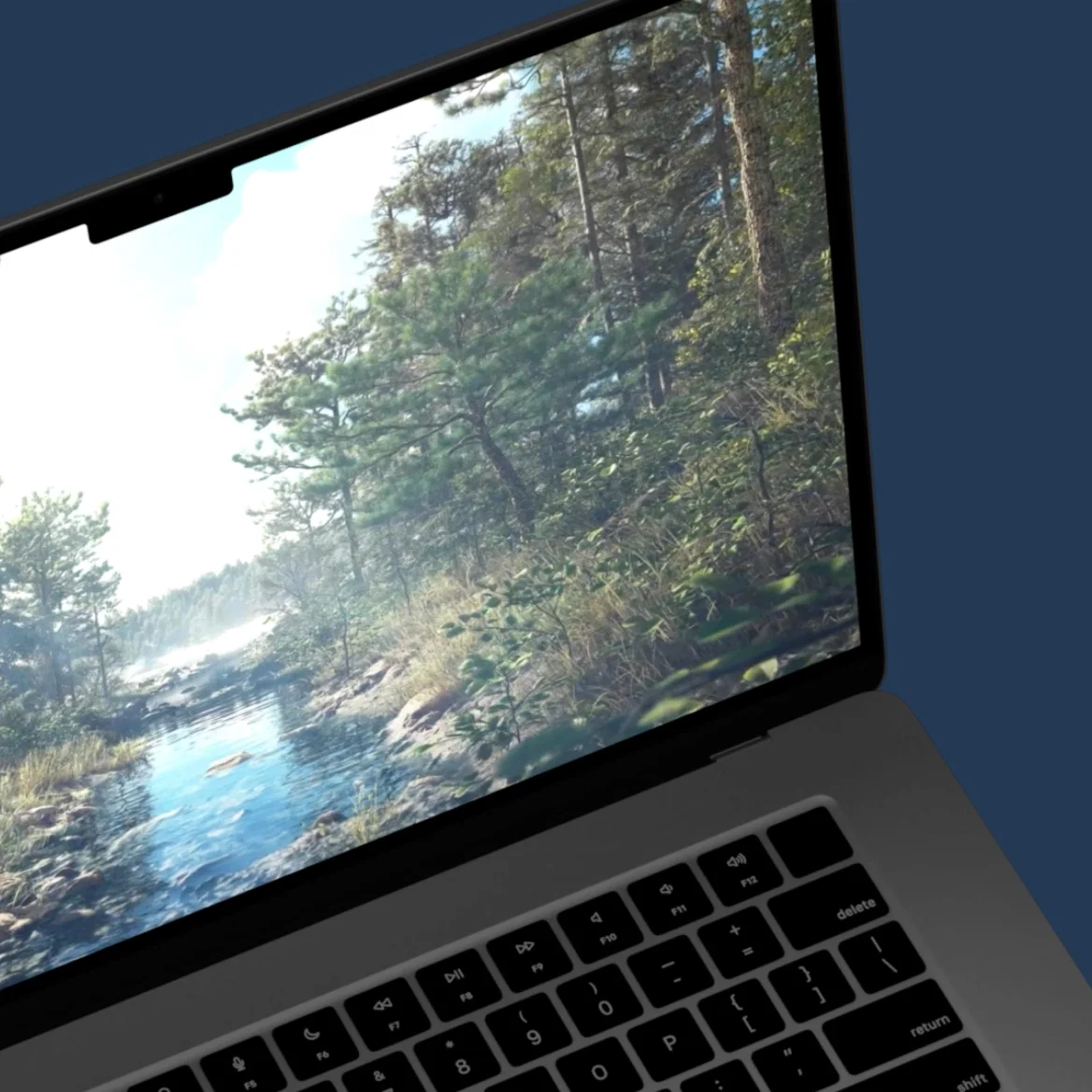 Laptop displaying a realistic 3D forest landscape render.