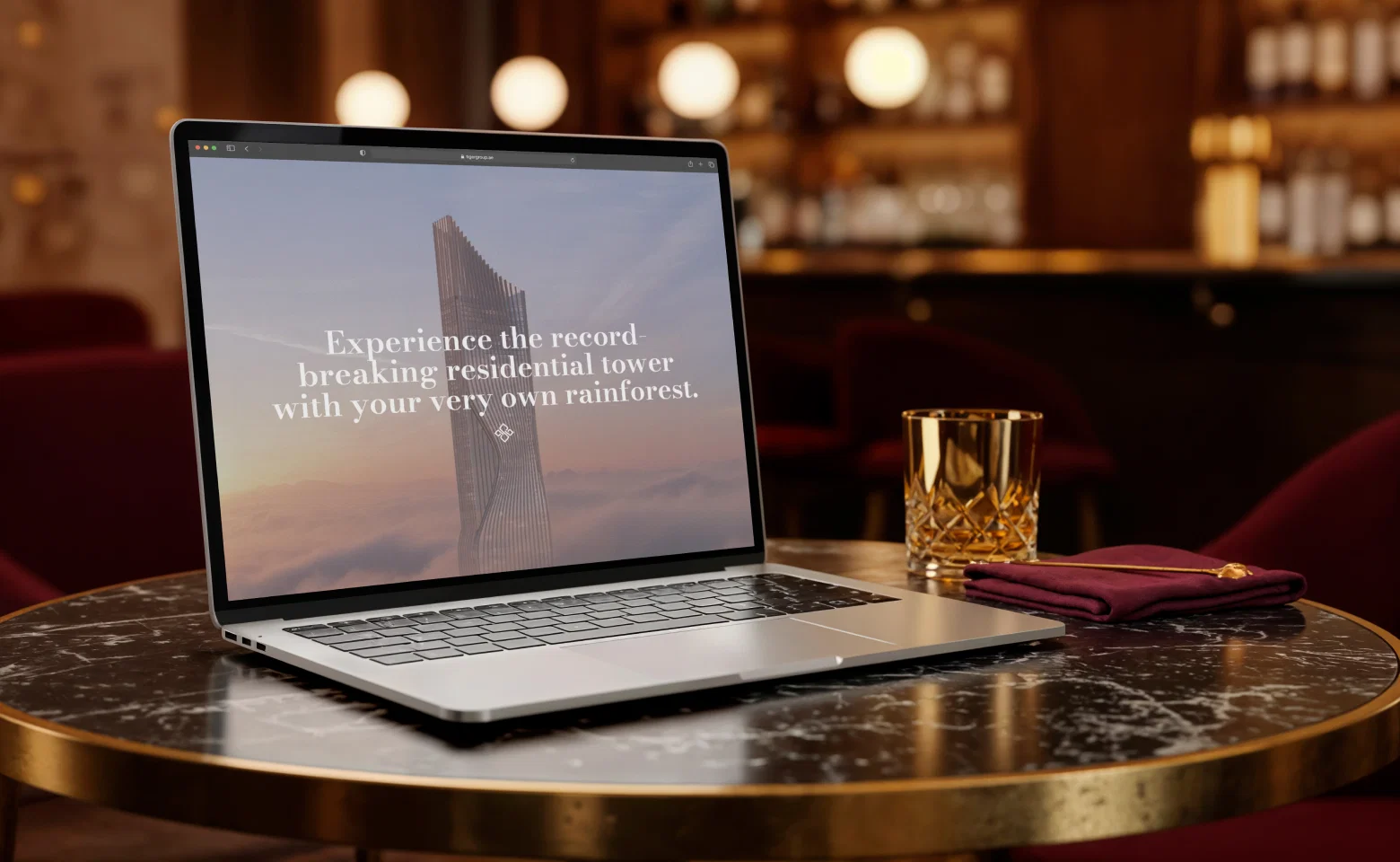 Laptop on marble table displaying Tiger Sky Tower promotional website.