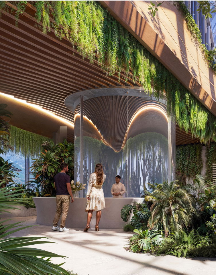 Green indoor reception area with tropical plants and modern architectural design.