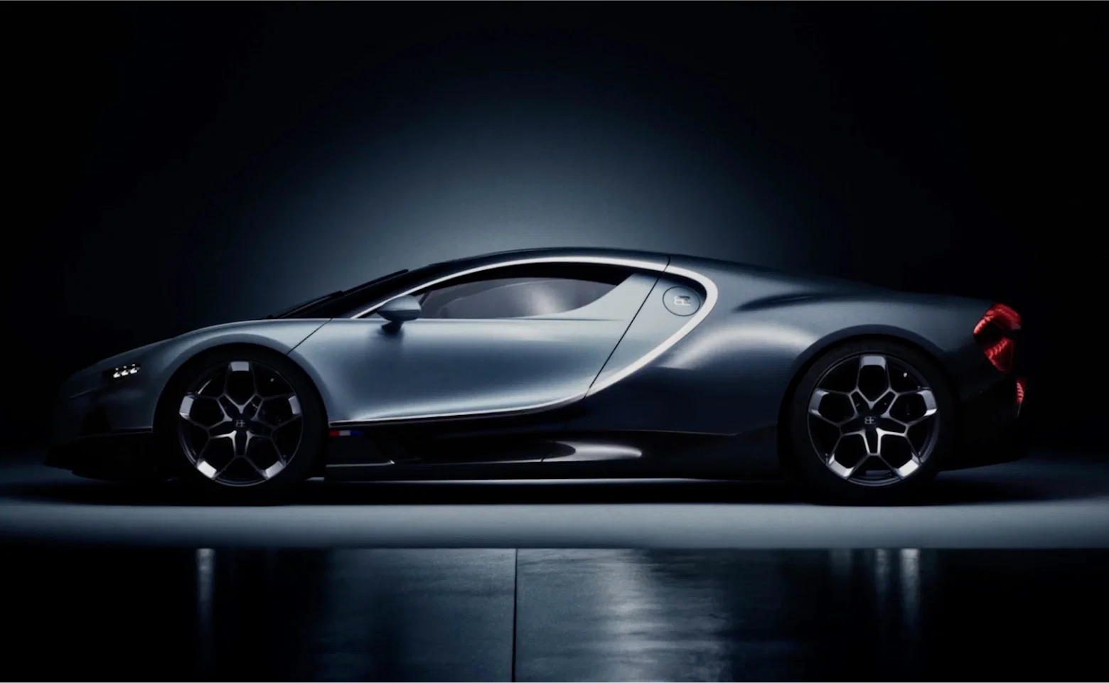 Bugatti Chiron side profile in dramatic lighting.