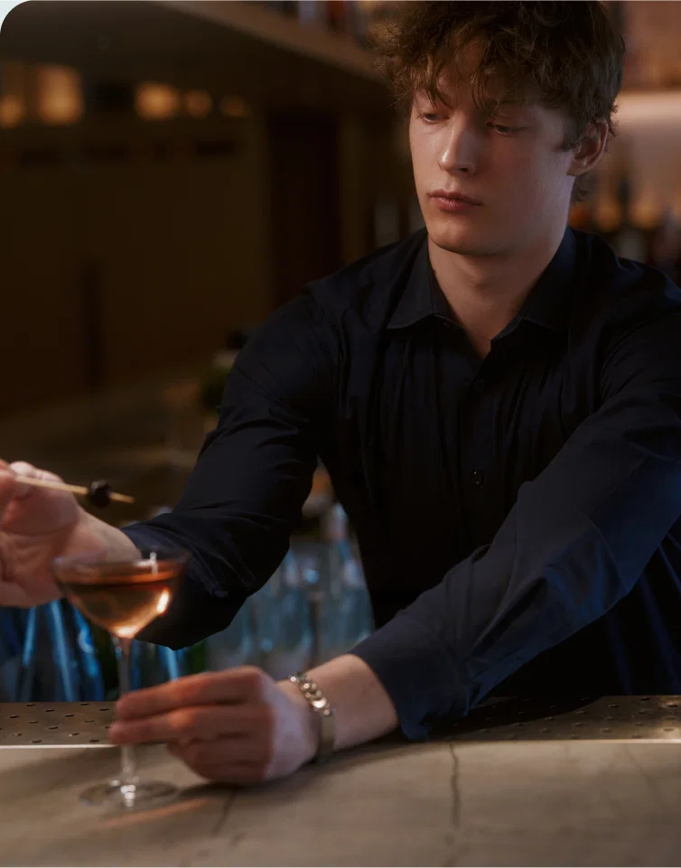 Bartender serving cocktail at stylish bar