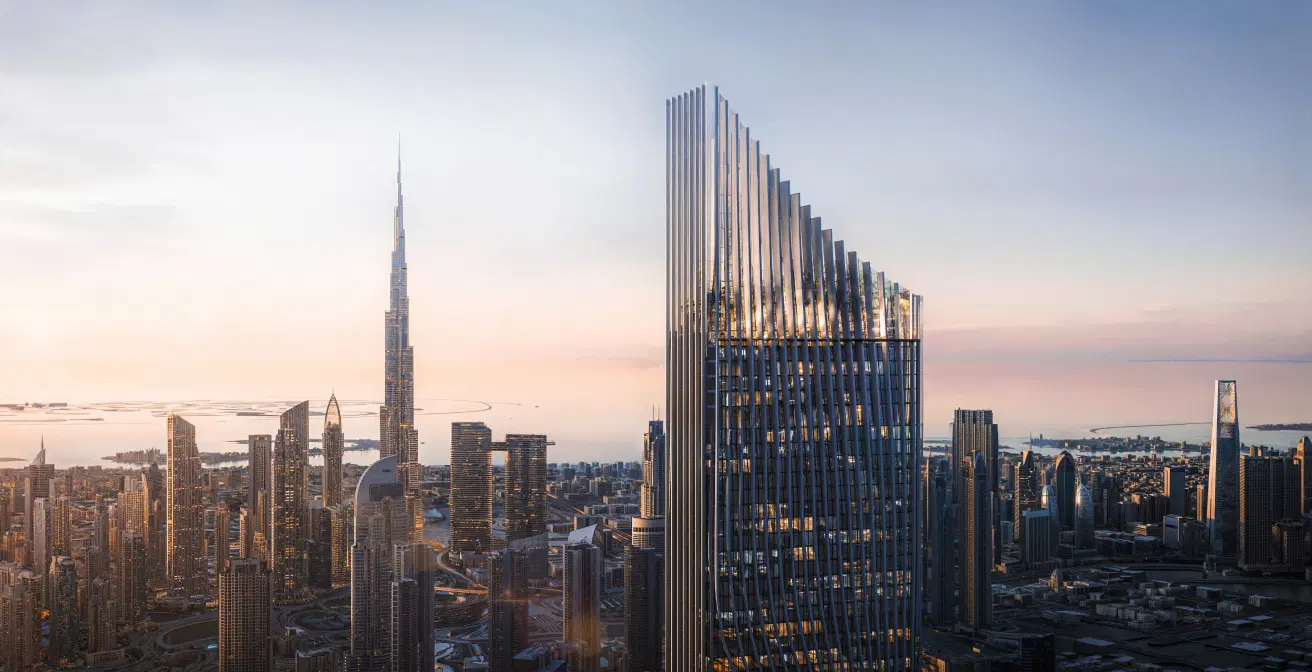 Modern glass skyscraper in Dubai skyline reflecting evening light.