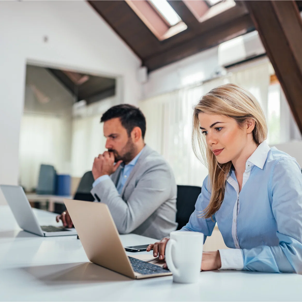 Team collaborating at desks in a creative open office space.